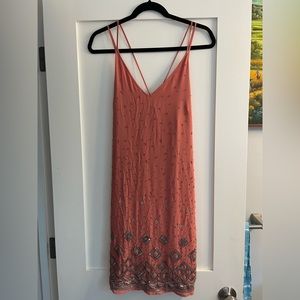 Size M   Never worn. Beautiful beading with extra beads provided.